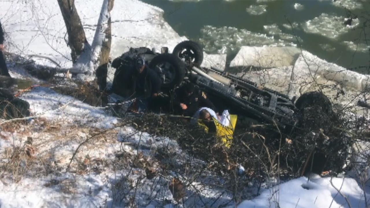 Police rescue driver submerged in icy waters