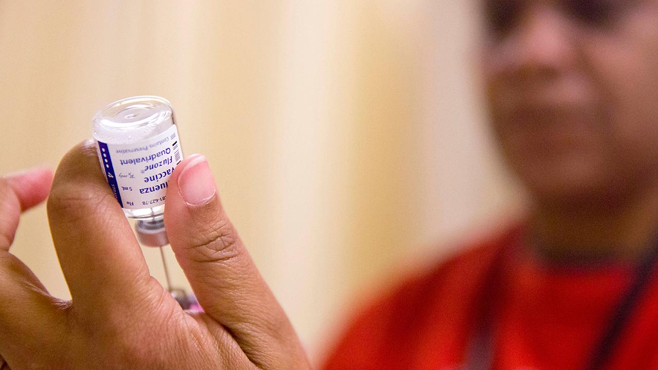 Health officials defend flu shots as outbreak grips nation