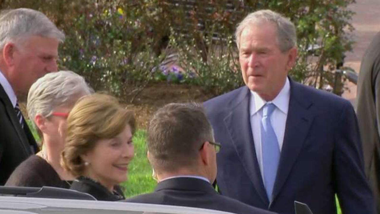 George W. Bush and Laura Bush pay respects to Billy Graham
