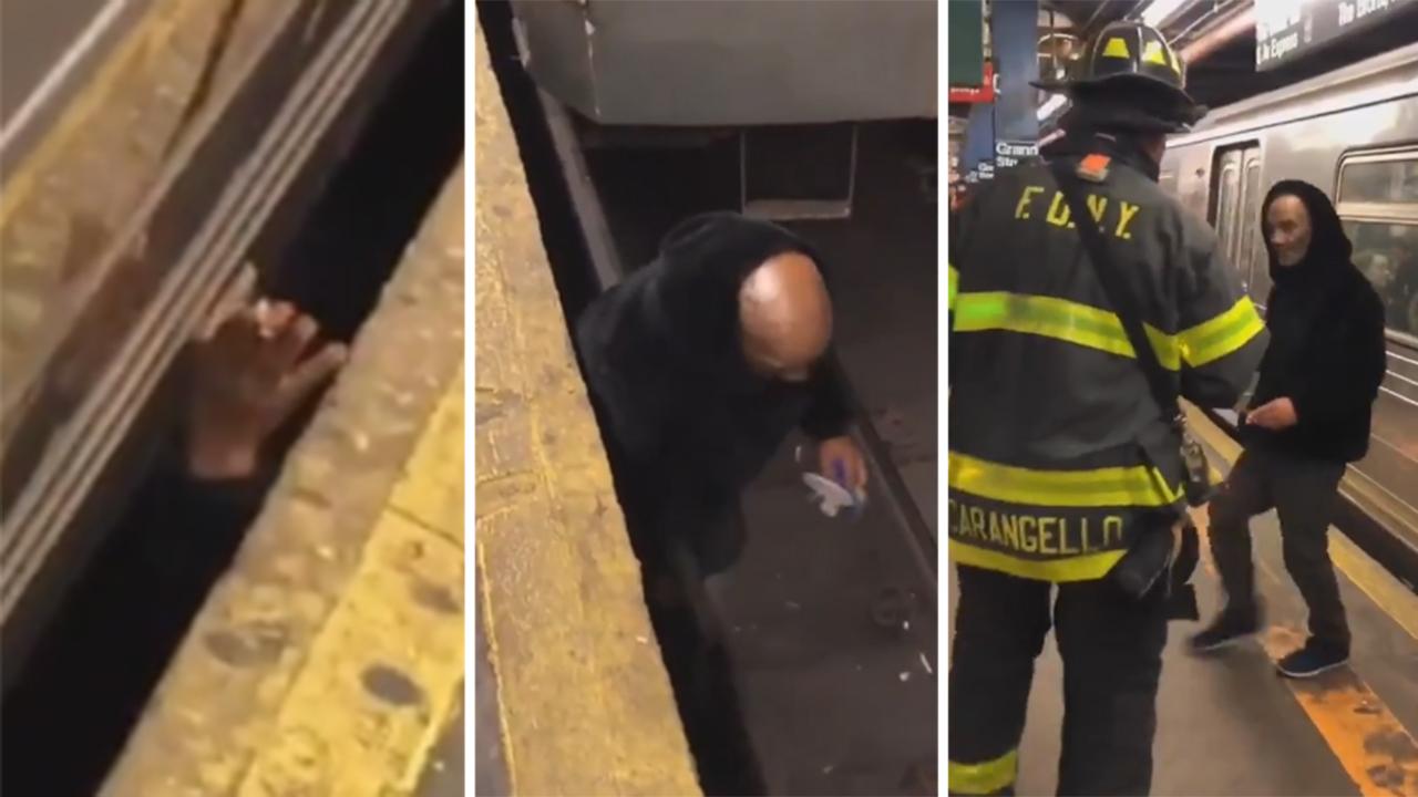 Man emerges from underneath NYC subway shocking commuters
