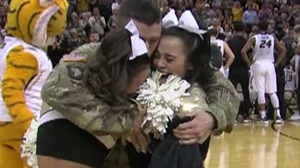 Soldier dad surprises twin cheerleaders at basketball game
