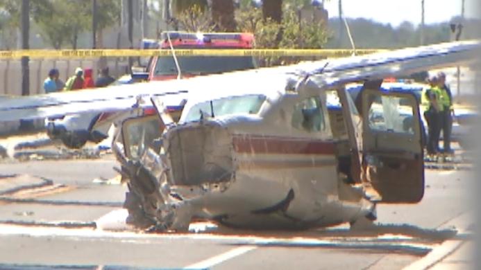 Small plane crashes into street nearly hitting cars