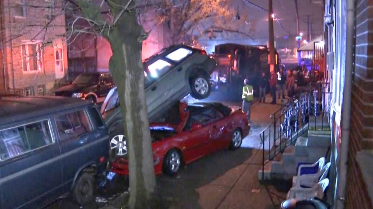 Philadelphia trash truck smashes row of parked cars
