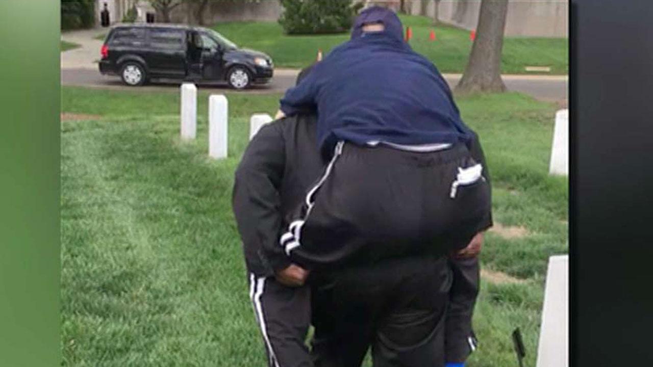 Volunteer carries veteran to see wife's grave
