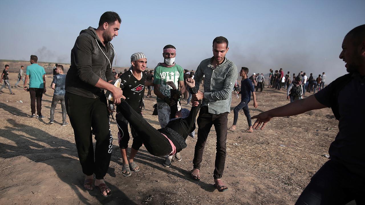 Violence at Gaza border subsides as Palestinians mourn dead