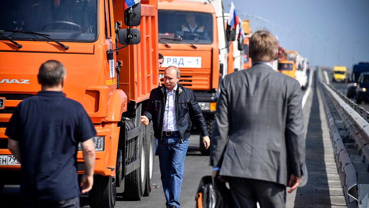 Putin rolls into Crimea on new bridge