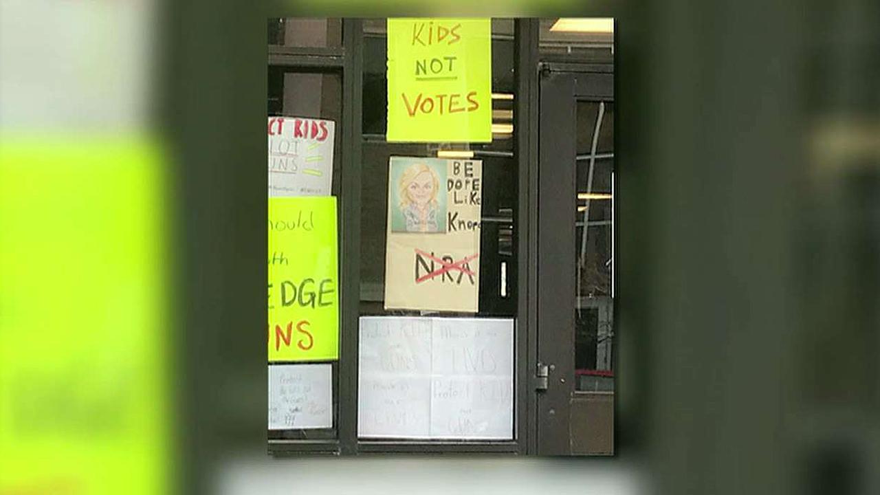 Anti-NRA, anti-GOP signs at school covered, but still up