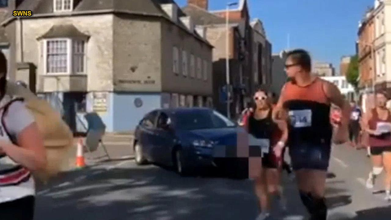 Angry woman drives car into path of half marathon