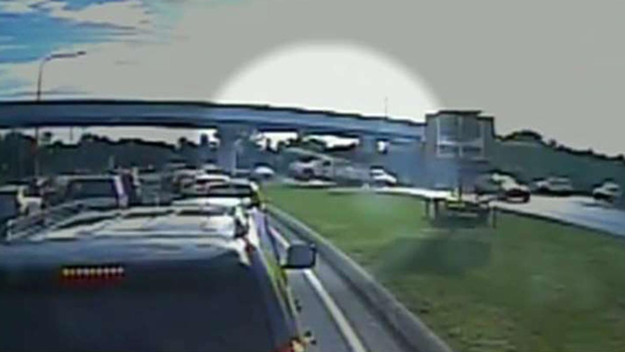 Truck goes airborne across highway, lands on 3 cars