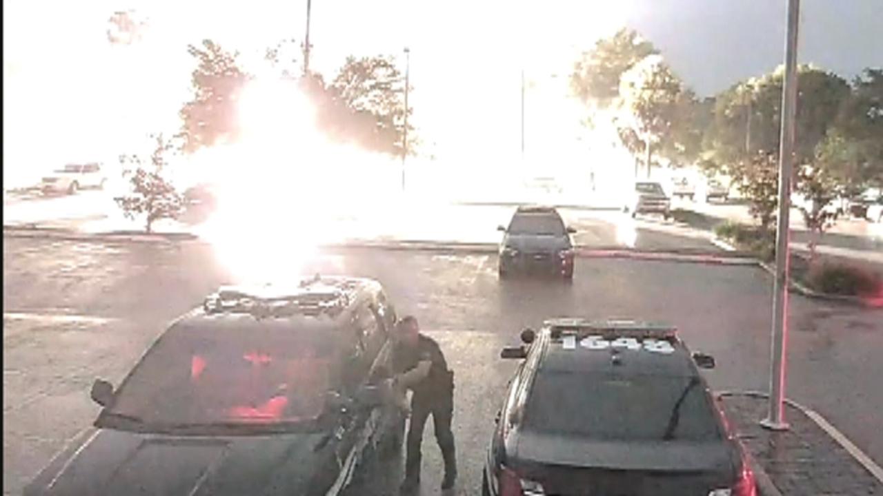 Lightning strikes feet away from police officer
