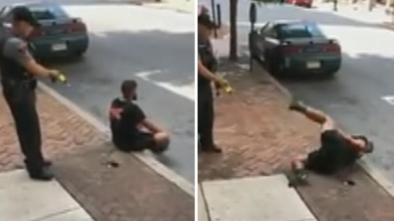 Cop uses stun gun on man sitting on curb