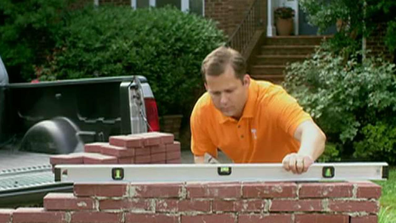 Republican congressional candidate builds wall in new ad