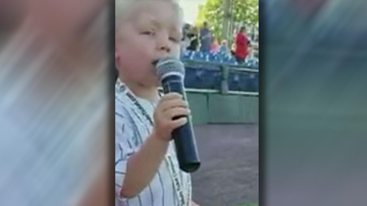 Boy wows baseball fans by singing the national anthem