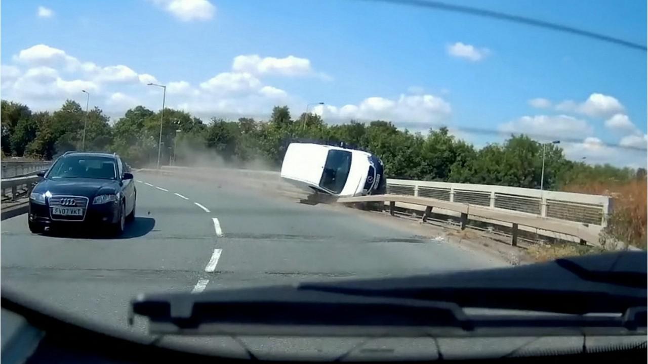 Out of control van grinds road barrier like a skateboarder