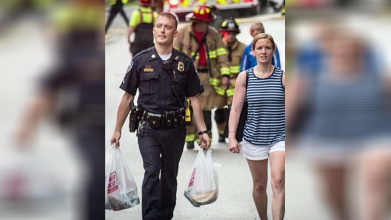 Cop helps carry woman's groceries uphill after fire