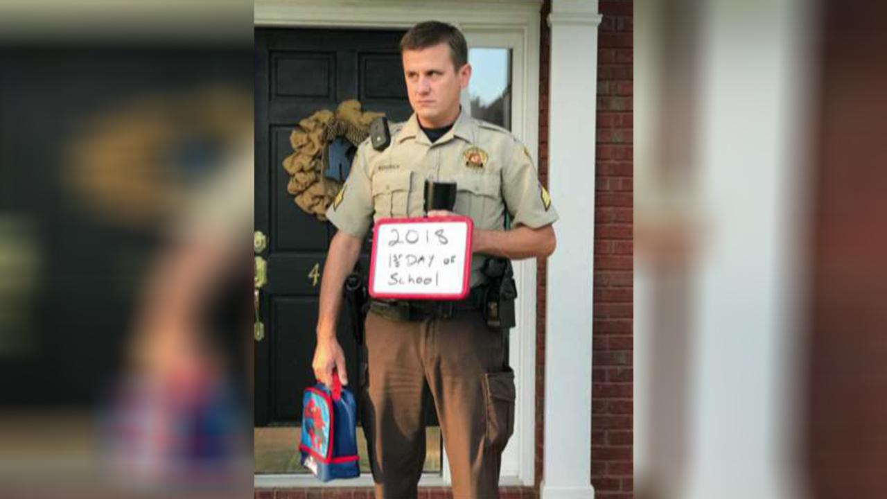 Alabama officer's reluctant back-to-school photo goes viral