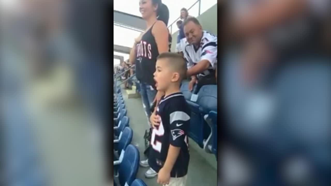 Young boy sings the national anthem