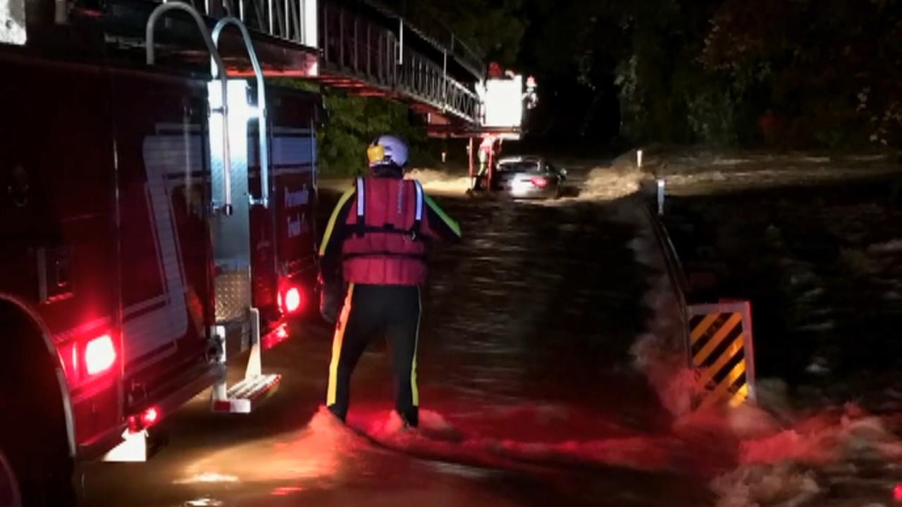 Father, sons rescued from Maserati trapped in floodwaters
