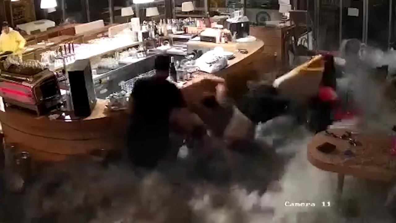 Wave crashes through restaurant window, sweeps workers away