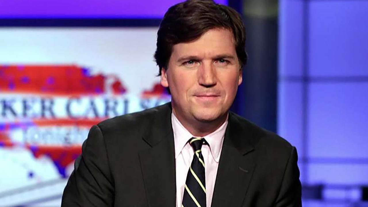 Antifa protesters chant outside Tucker Carlson's home