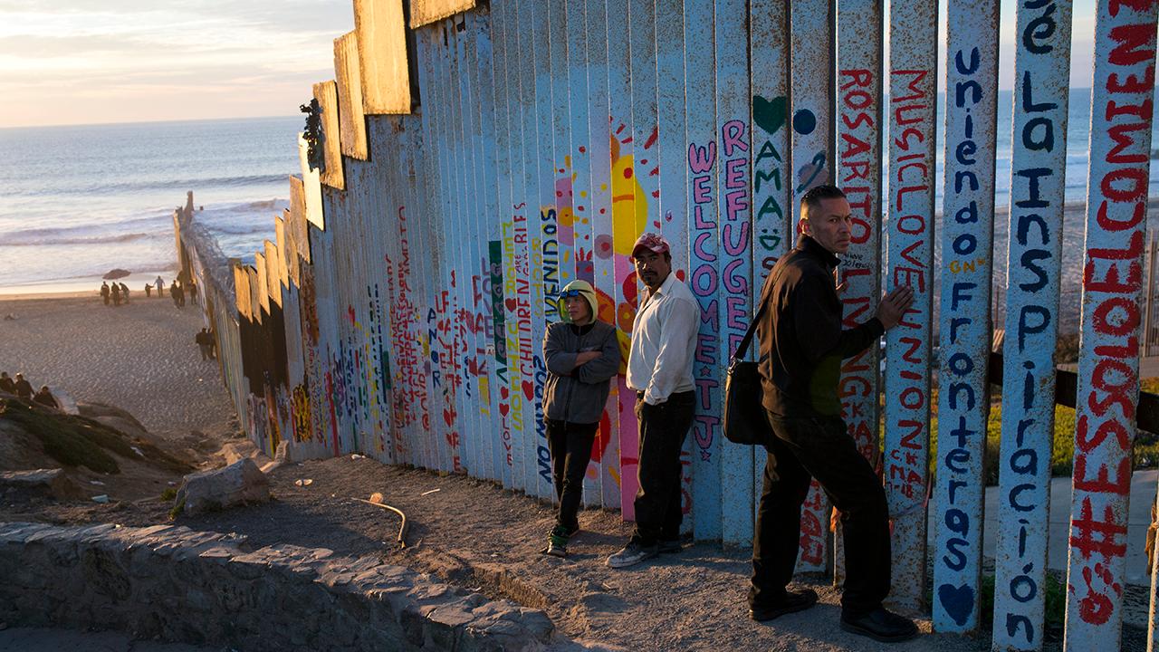 Arrival of migrant caravan renews focus on border wall