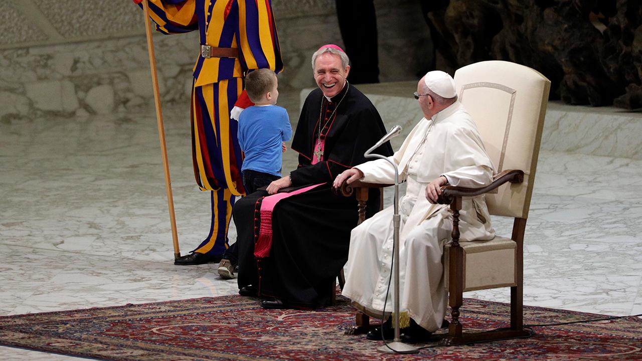 Pope laughs when little boy runs onto stage at Vatican