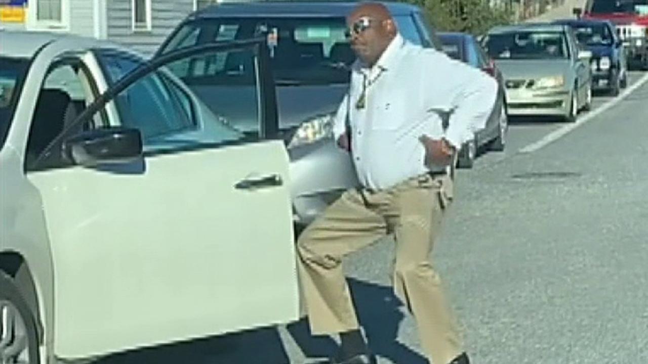 Police officer comes out of car and dances during backed-up rush hour traffic