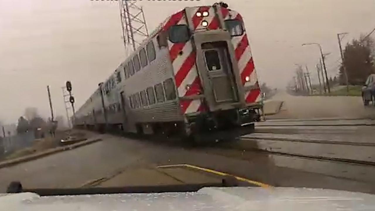 Cop nearly crashes into oncoming train after crossing gates fail to lower