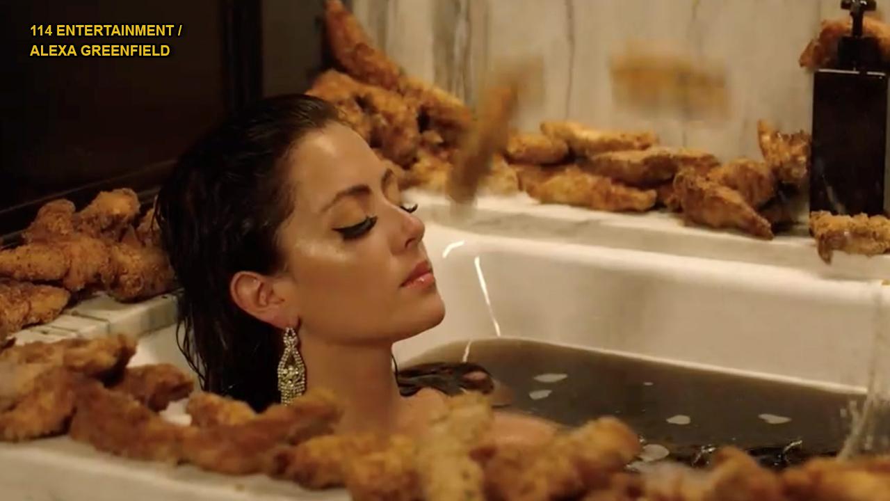 Woman caught dipping chicken tenders in soda at US Open releases music video