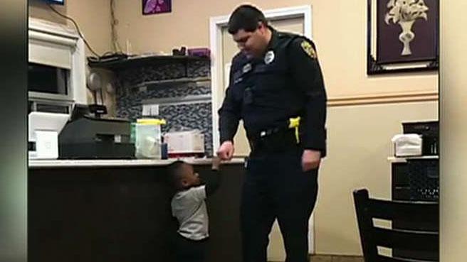 Caught on camera: 2-year old boy gives police officer hug and fist bump in heartwarming moment
