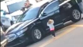 Toddler exits vehicle with hands up following her parent's arrest