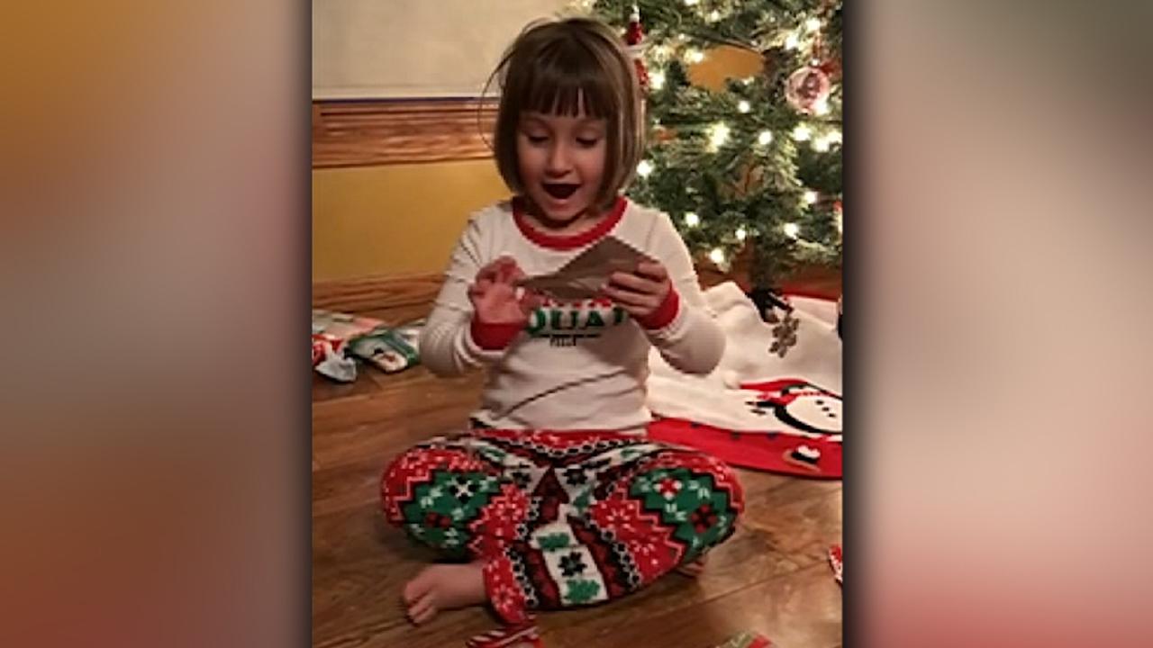 Little girl screams in excitement after getting a Taco Bell gift card for Christmas