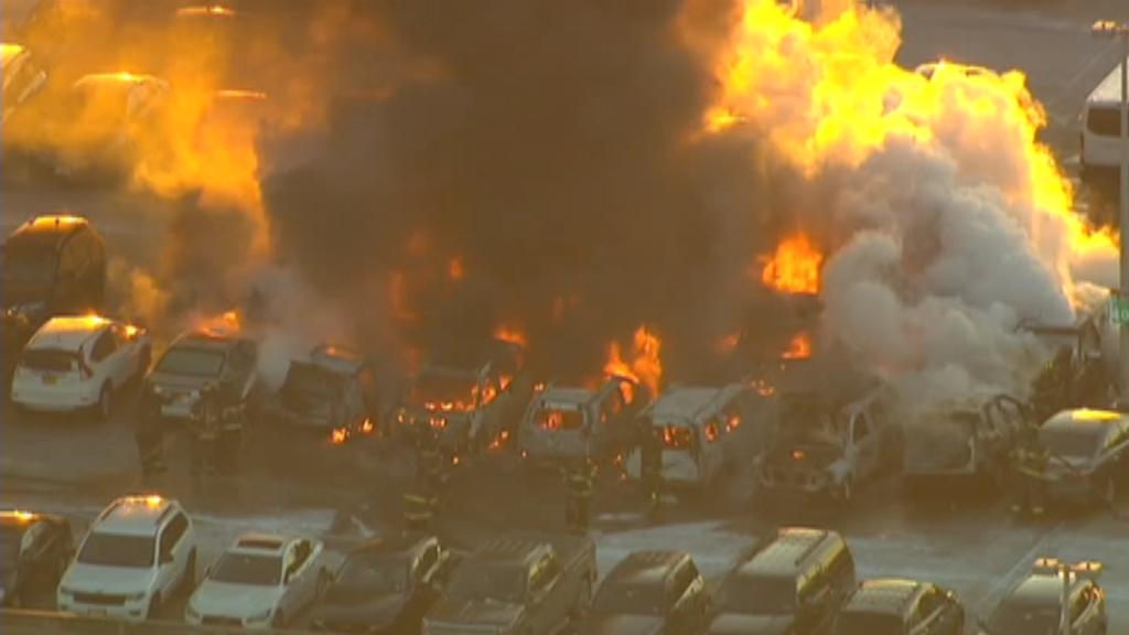 Firefighters worked to put out a raging fire at a Newark Airport parking garage; no injuries reported