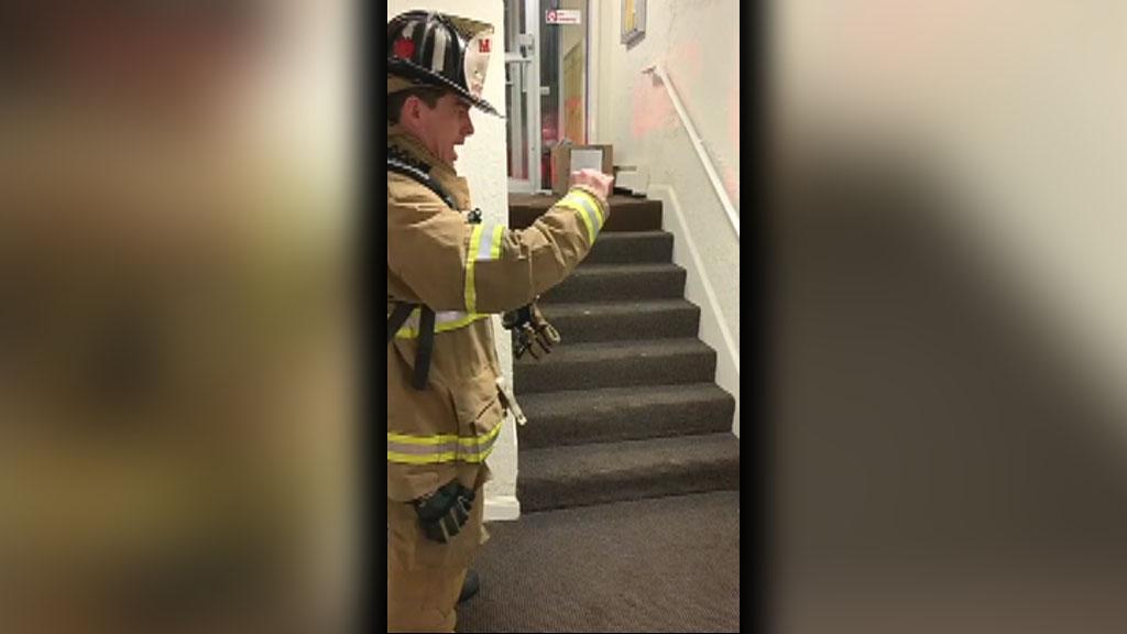 New Hampshire firefighter uses sign language with young boy