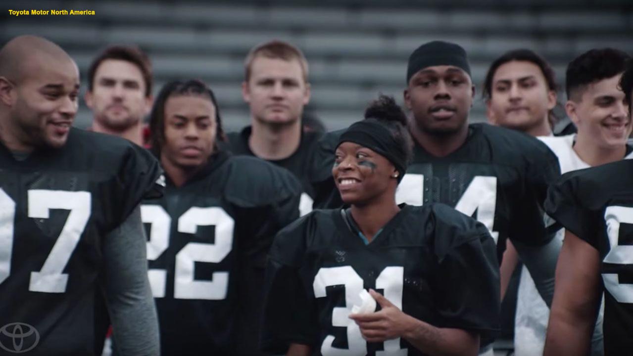 A woman makes history as the first female football player to get a full scholarship to play in college