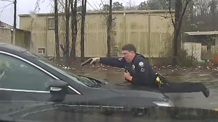 Arkansas police officer on hood of car fires at driver through windshield 15 times
