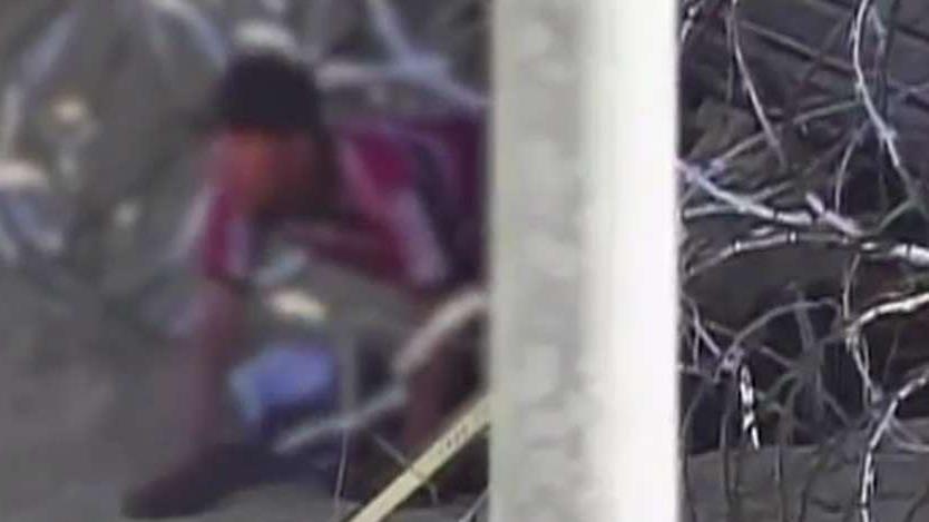 Video shows 171 migrants crawling through hole under border fence in Yuma, Arizona