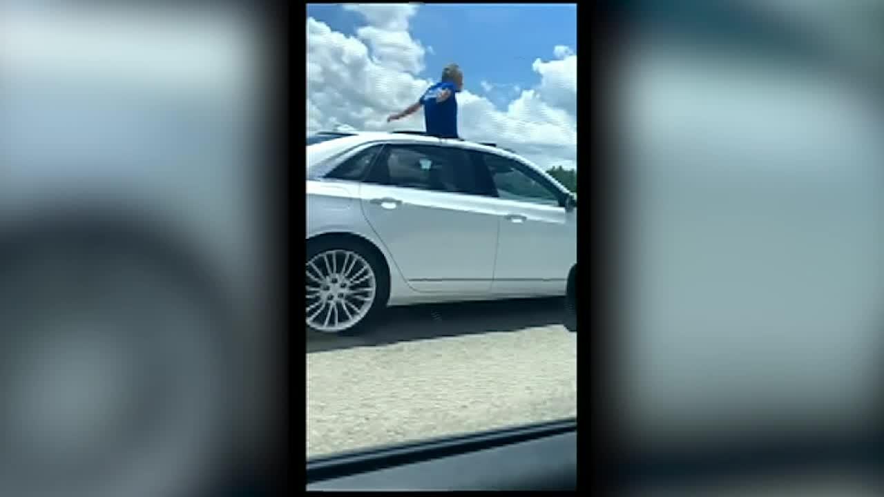 Florida man stands in sunroof while driving