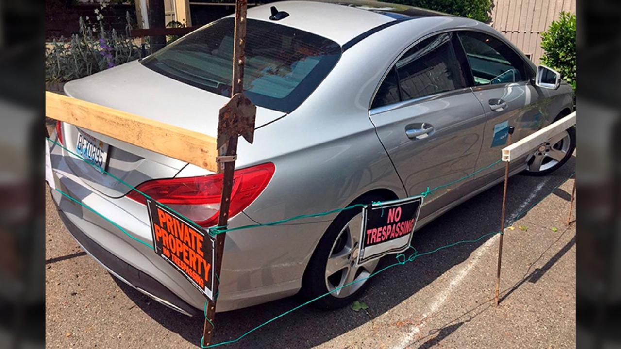 Seattle man builds fence around illegally parked car-share vehicle on property; demands payment
