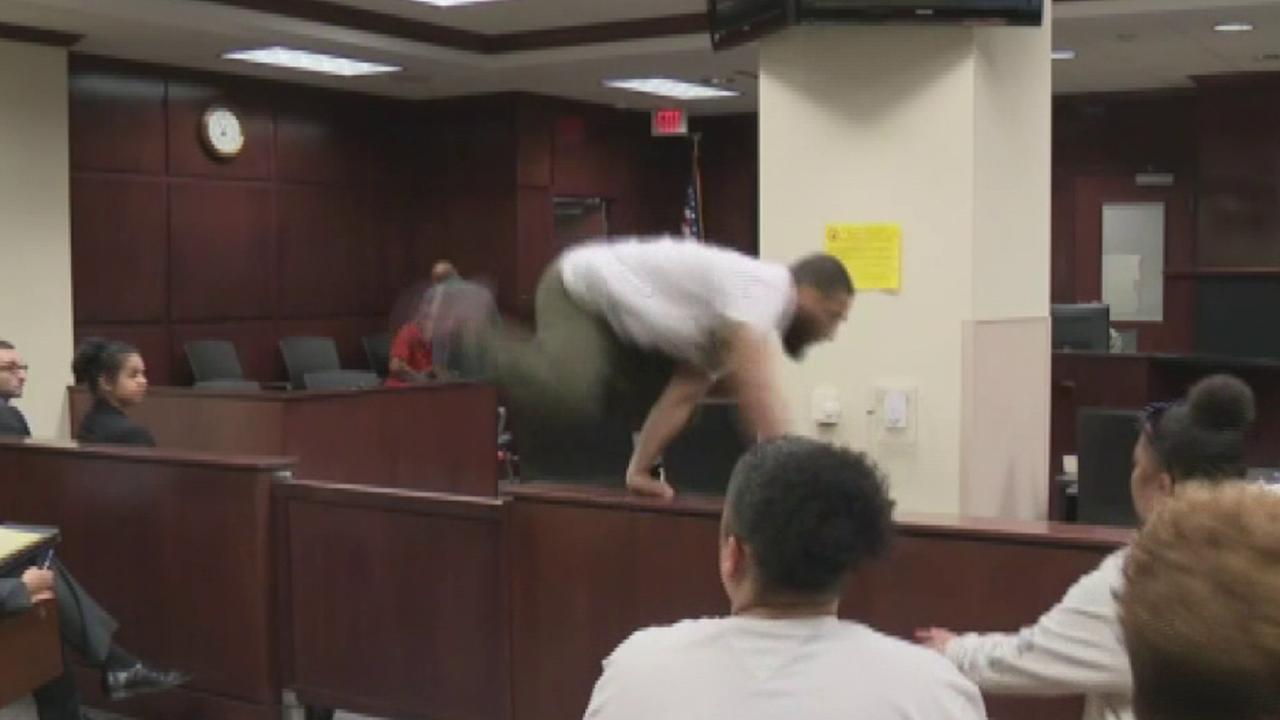 Raw video: Son of murdered woman tries to attack suspected killer in court	