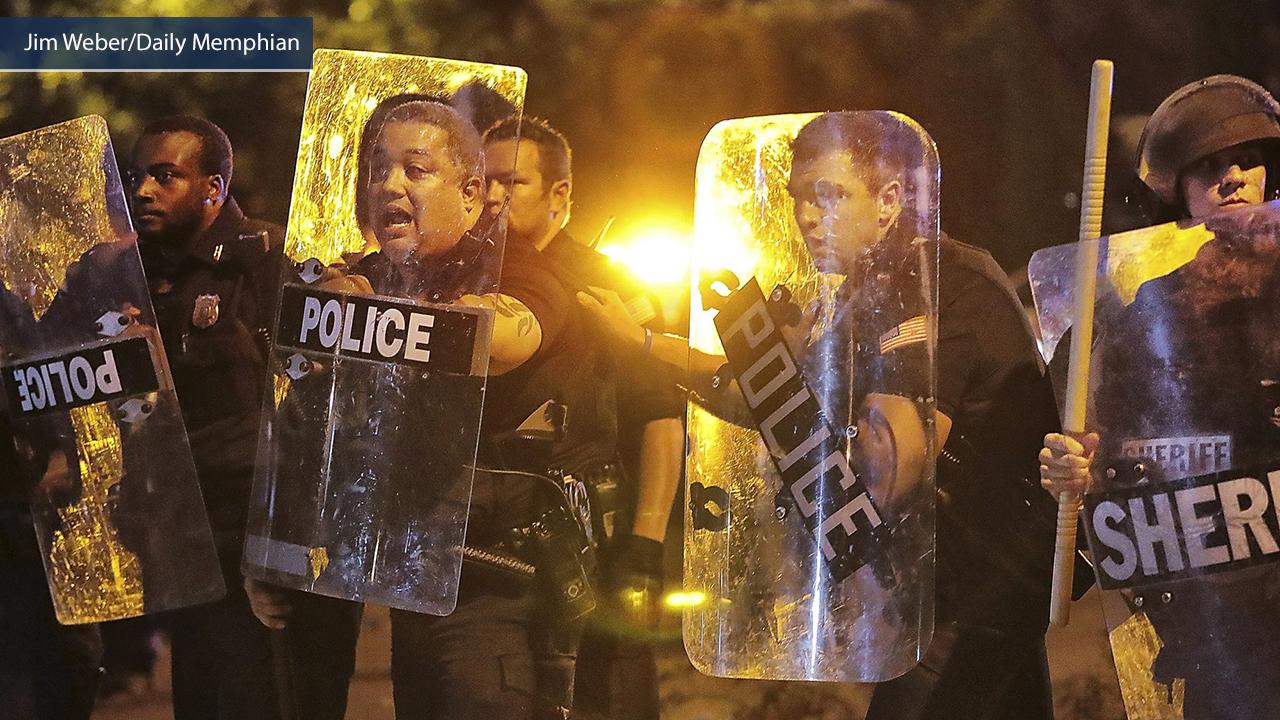 Demonstrators smashing cop car during violent riots in Memphis