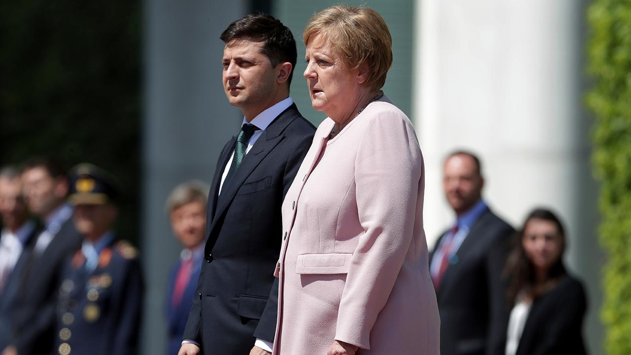 Angela Merkel appears to shake uncontrollably at ceremony with the new Ukrainian president