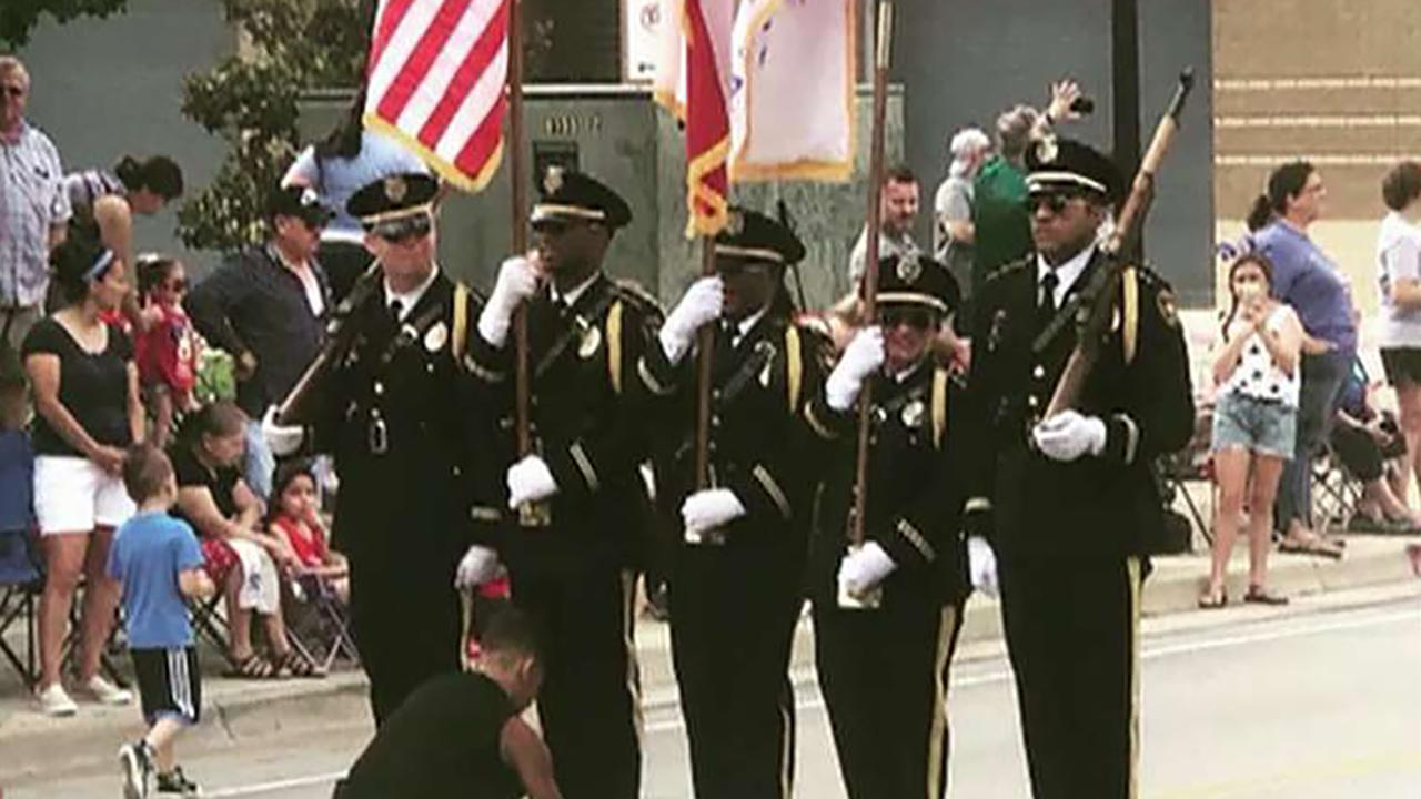 Boy steps in to tie honor guard's shoe during Texas Fourth of July parade