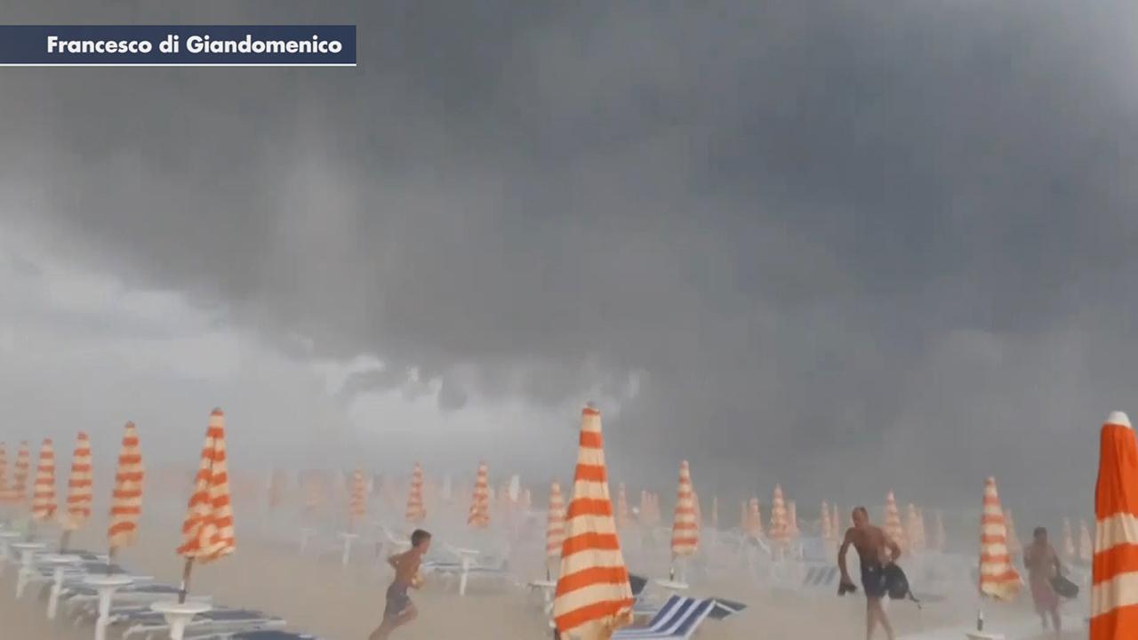 Sunbathers flee as freak storm hits beach in Italy