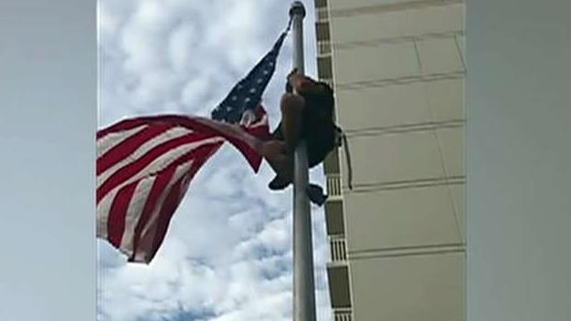 Retired Navy SEAL climbs flag pole to fix flag
