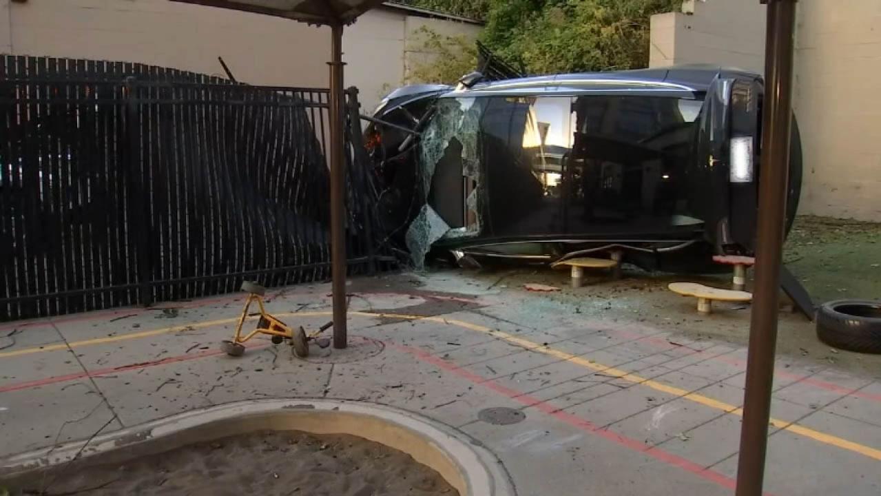 Driver survives crashing his Tesla off cliff into daycare playground