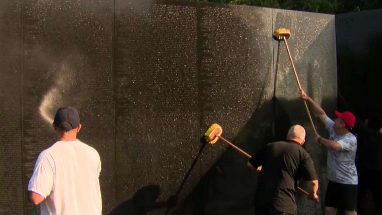 Bipartisan group of lawmakers hand-wash Vietnam Veterans Memorial