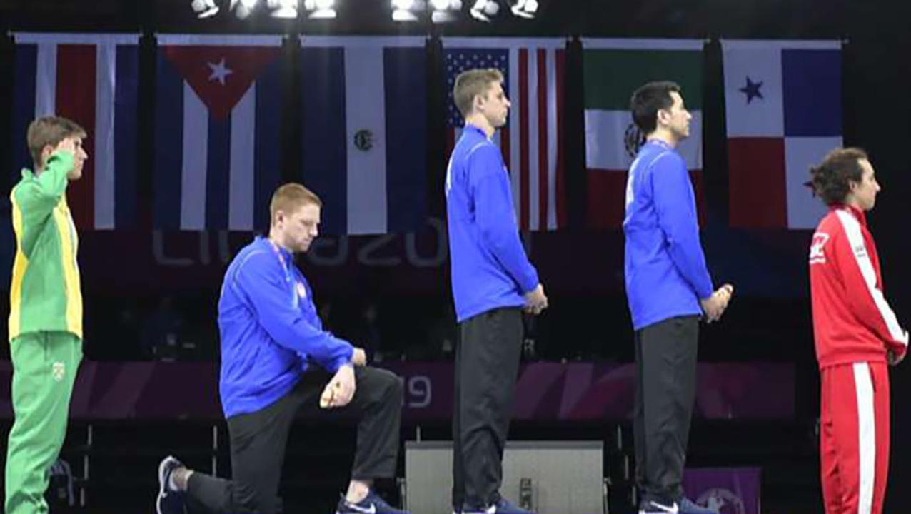 US fencing team kneels for national anthem after winning gold medal