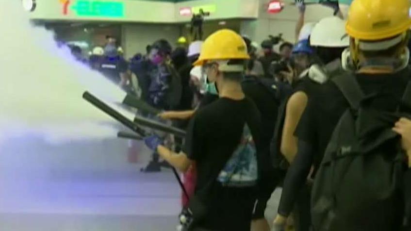 Hong Kong police and protesters clash at train station