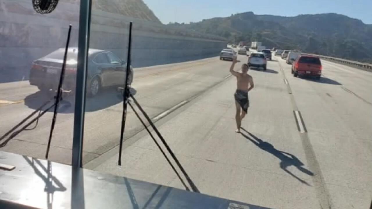 Nearly naked man attacks school bus